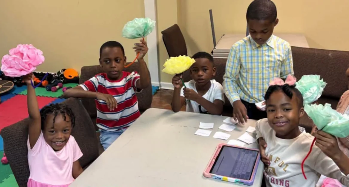 REC children holding paper crafts during a children and youth activity
