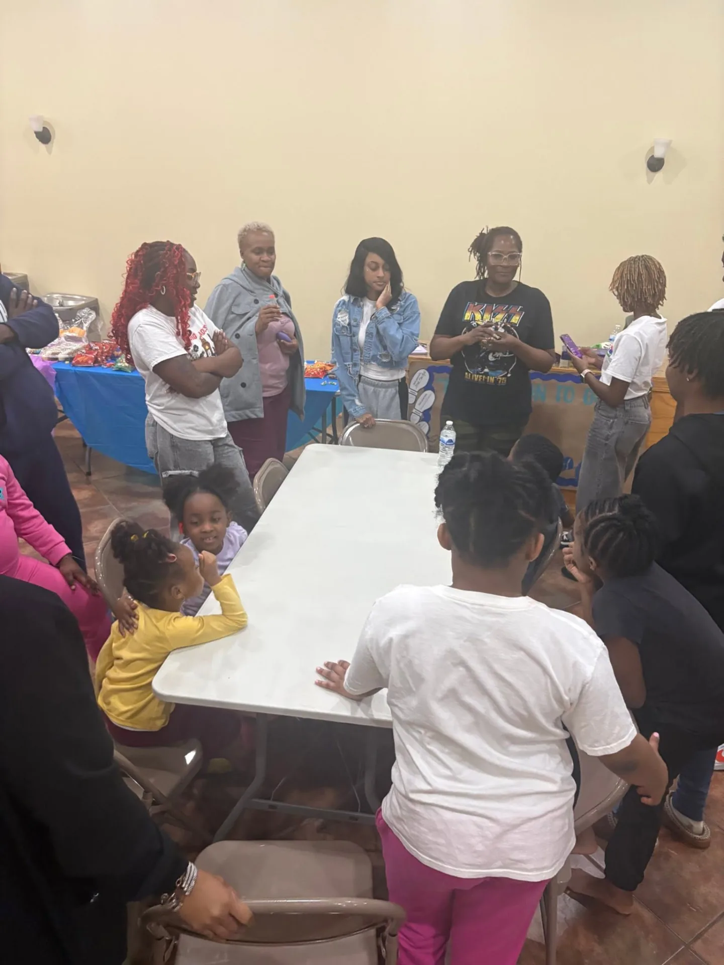 REC families and volunteers gathered around a table during a fellowship gathering